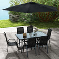 Sfeerco Riviera 8-piece patio dining set in black styled in garden setting with umbrella open