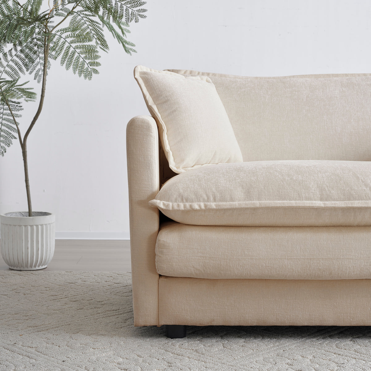 Sfeerco Dune sofa close-up detail showing beige chenille fabric texture and black wooden leg finish