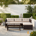 Sfeerco Laguna outdoor rattan sectional sofa set styled on garden patio with hedge backdrop