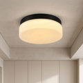 Sfeerco Nero 12-inch round flush mount LED ceiling light in black with marble glass shade installed in modern living room