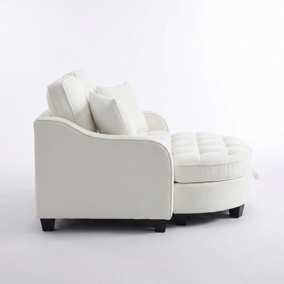 Side profile of Sfeerco Nido white sofa showing curved irregular armrest and tufted cushioning