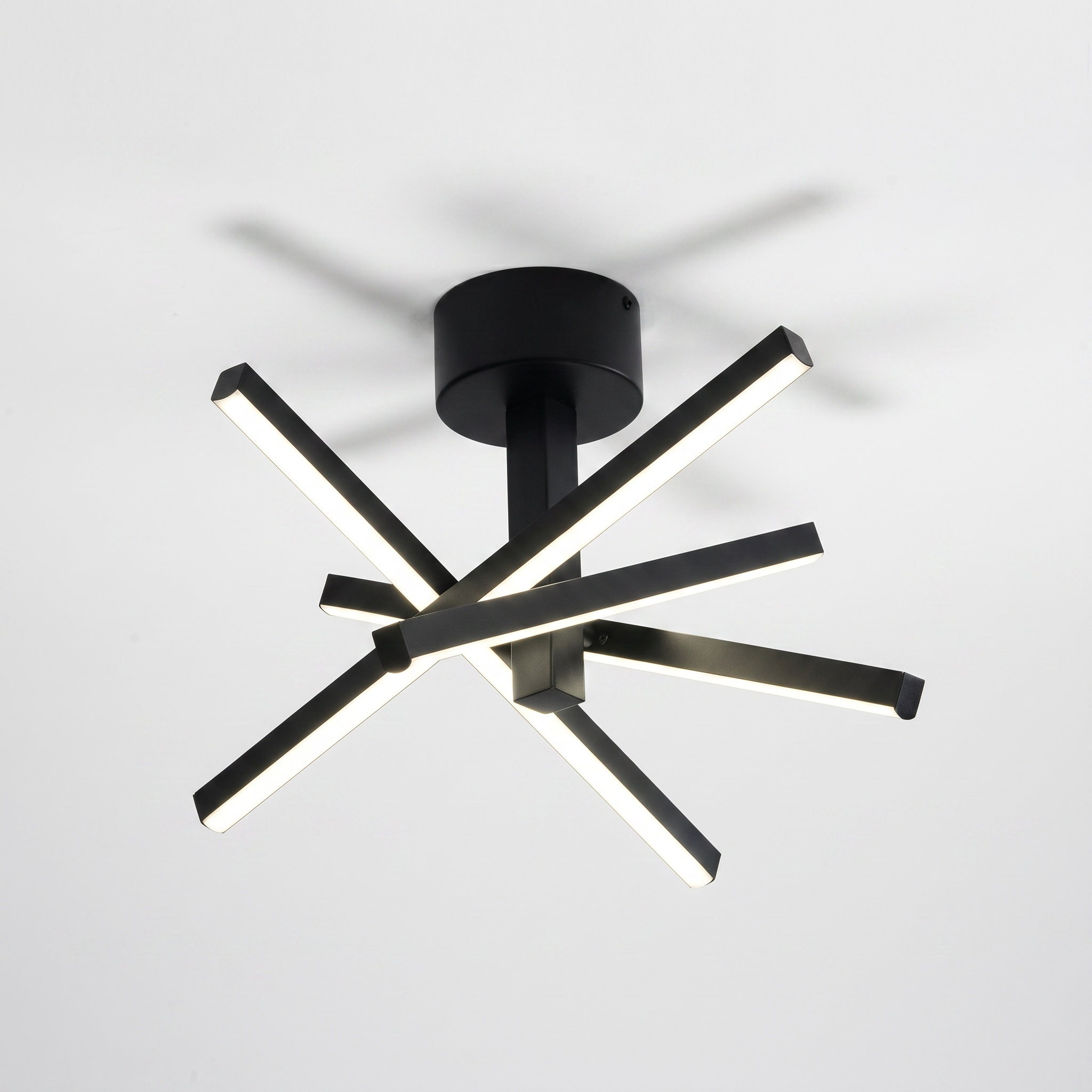 Sfeerco Nova 12-inch geometric starburst LED ceiling light in matte black on grey background
