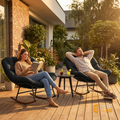 Couple relaxing on Sfeerco Rondo outdoor papasan rocking chairs on wooden deck surrounded by garden