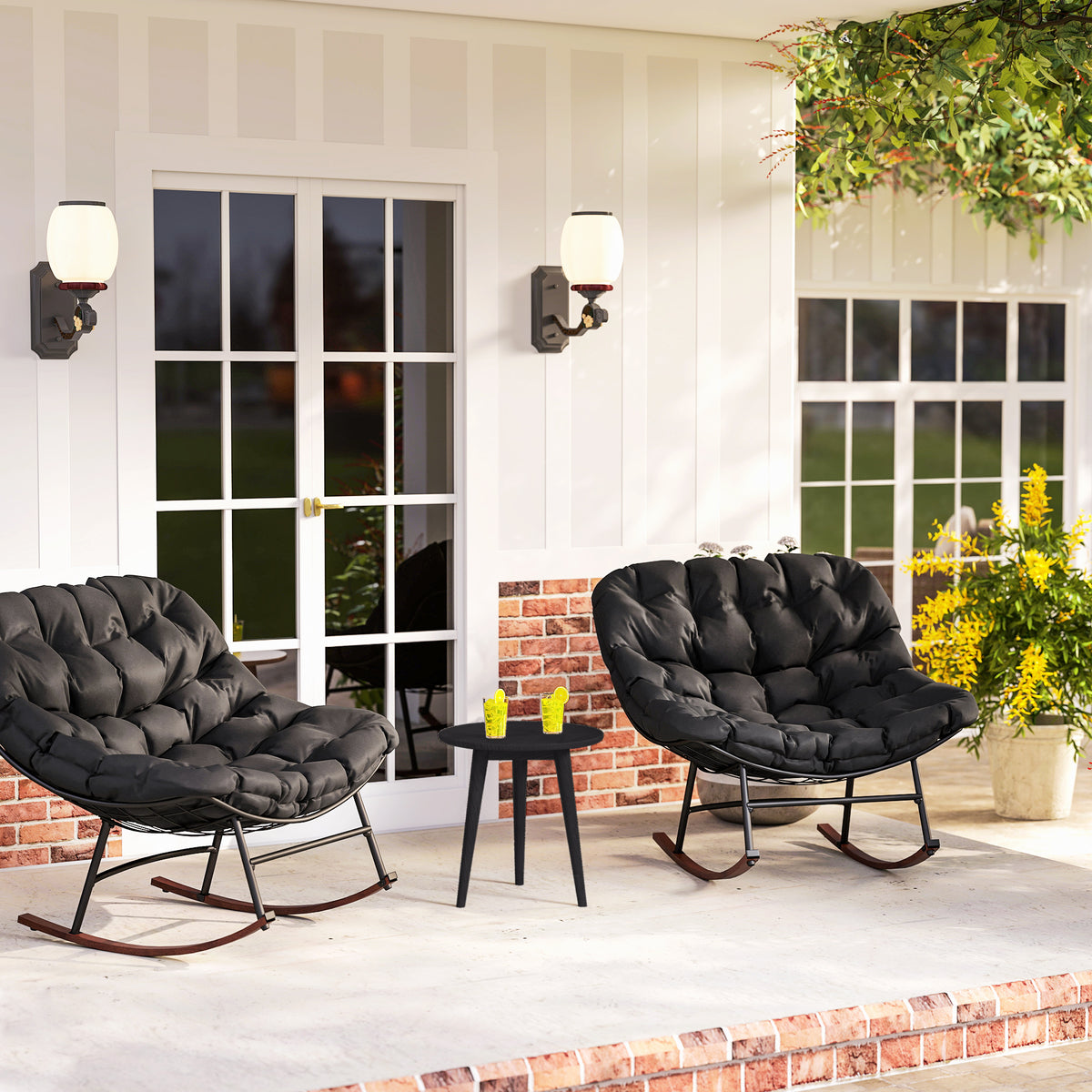 Sfeerco rondo set of 2 black papasan rocking chairs with cushions on covered porch with flower wall