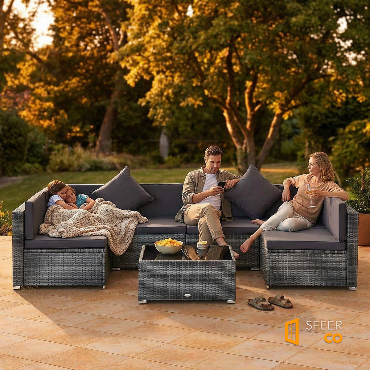 Family relaxing on Sfeerco Slate 7-piece rattan patio sofa set during golden hour on outdoor terrace